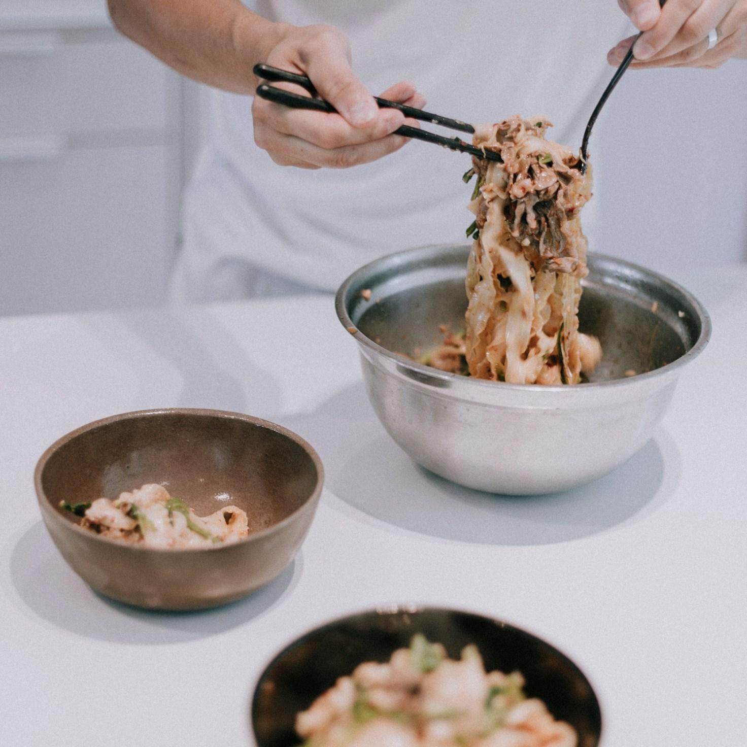 Community members working together in a contemporary kitchen, exchanging recipes and techniques